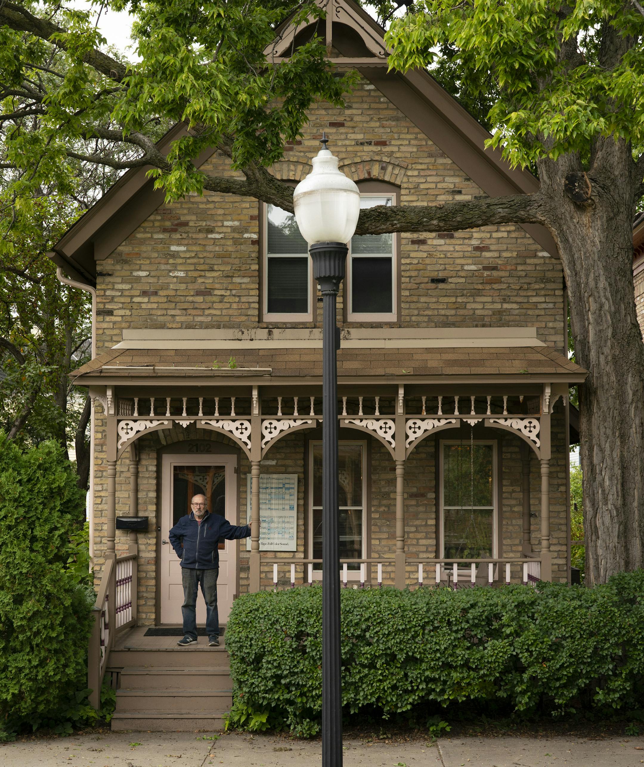 Bob Roscoe on the porch of the house on Milwaukee Ave. that he lived in from 1971-74, when he advocated for the restoration of the factory worker housing. ] JEFF WHEELER • jeff.wheeler@startribune.com The Milwaukee Ave. Historic District is 50 years old this year. Activist and architect Bob Roscoe lived in a house on the avenue and fought for the designation. He was photographed in front of the house he lived in from 1971-1974 on Tuesday afternoon, September 8, 2020 at Allianz Field in Minneapol