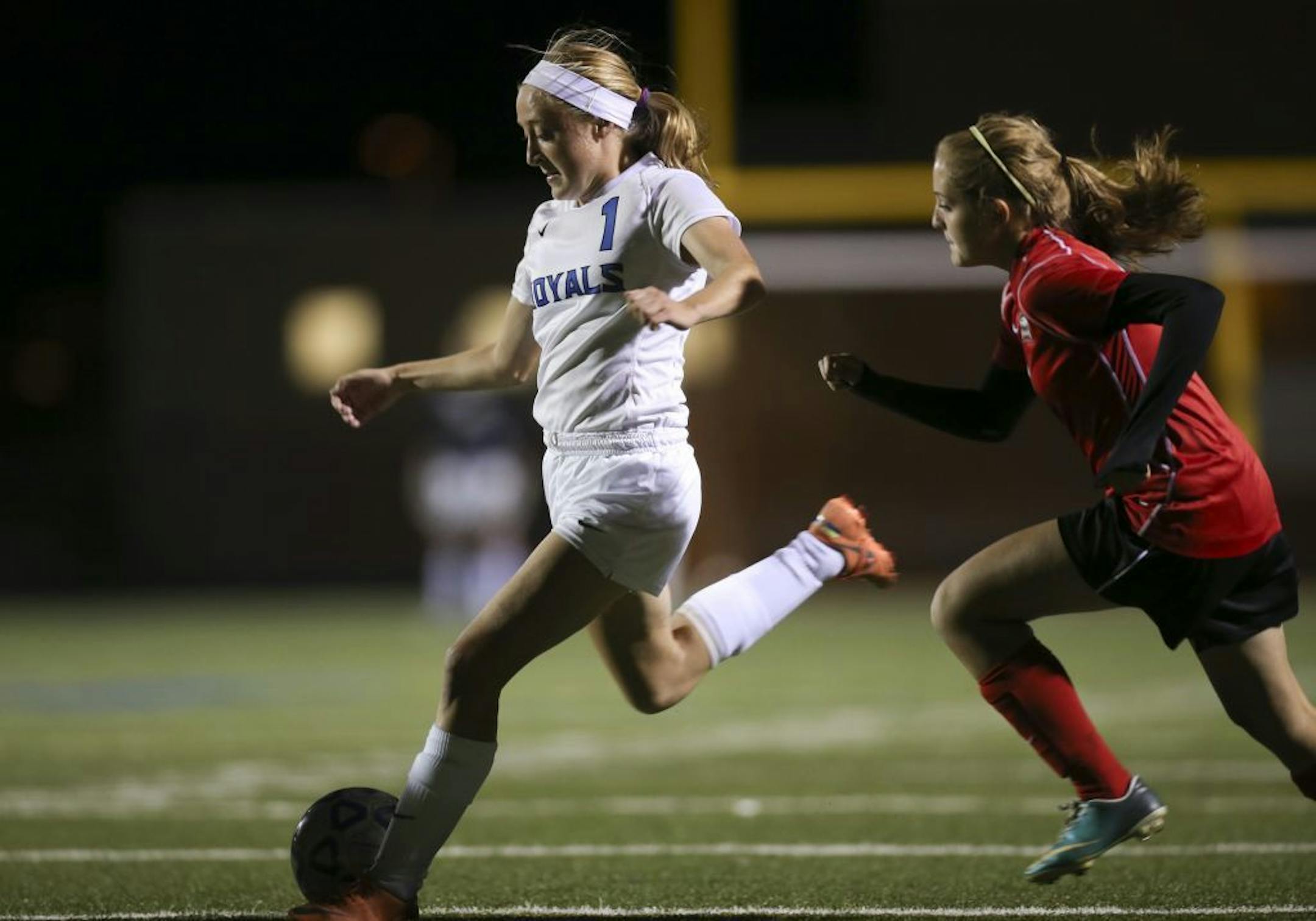 The Woodbury girl's soccer team beat North St. Paul 5-0 in a first round sectional tournament game at Woodbury High School Tuesday night, October 8, 2013. Woodbury's Rachel Hewitt scored the Royals' fourth goal on this first half shot while defended by North St. Paul's Maddie Johnson.