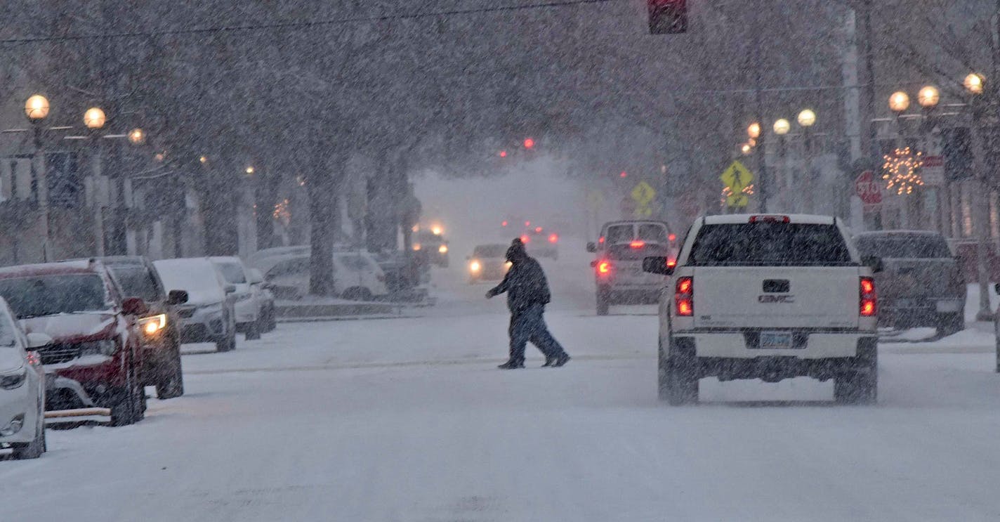 The streets were snow covered with traffic moving slowly during a winter storm Wednesday morning, Dec. 26, 2018, in downtown Bismarck, N.D. Forecasters say a post-Christmas winter storm could dump more than a foot of snow on parts of the Dakotas and Minnesota in the next several days.(Tom Stromme/The Bismarck Tribune via AP)