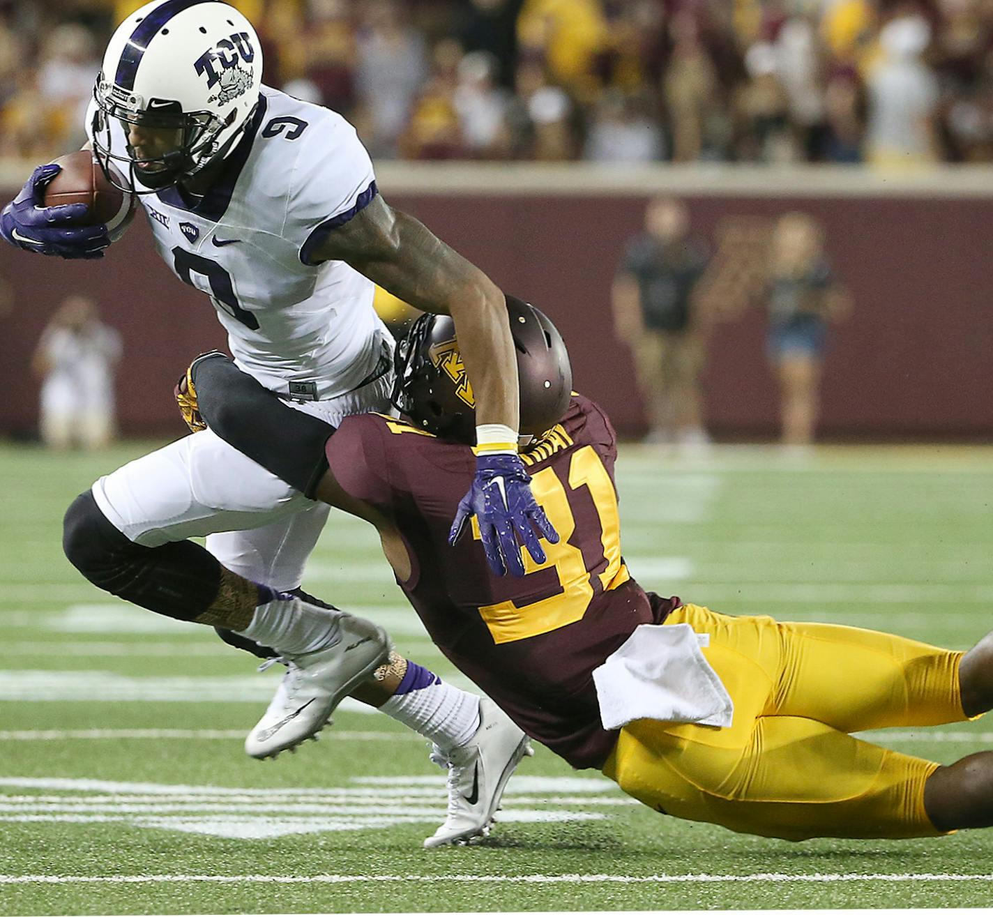 TCU Horned Frogs wide receiver Josh Doctson is tackled by Minnesota Gophers defensive back Eric Murray as he carried the ball in the second quarter as the Gophers took on TCU at TCF Stadium, Thursday, September 3, 2015 in Minneapolis, MN. ] (ELIZABETH FLORES/STAR TRIBUNE) ELIZABETH FLORES &#x2022; eflores@startribune.com