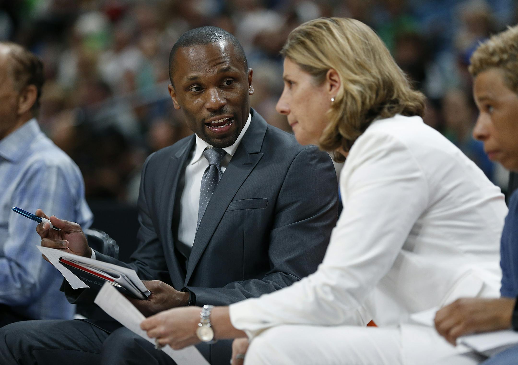 Lynx Head Coach Cheryl Reeve listened to former assistant coach James Wade during a game.