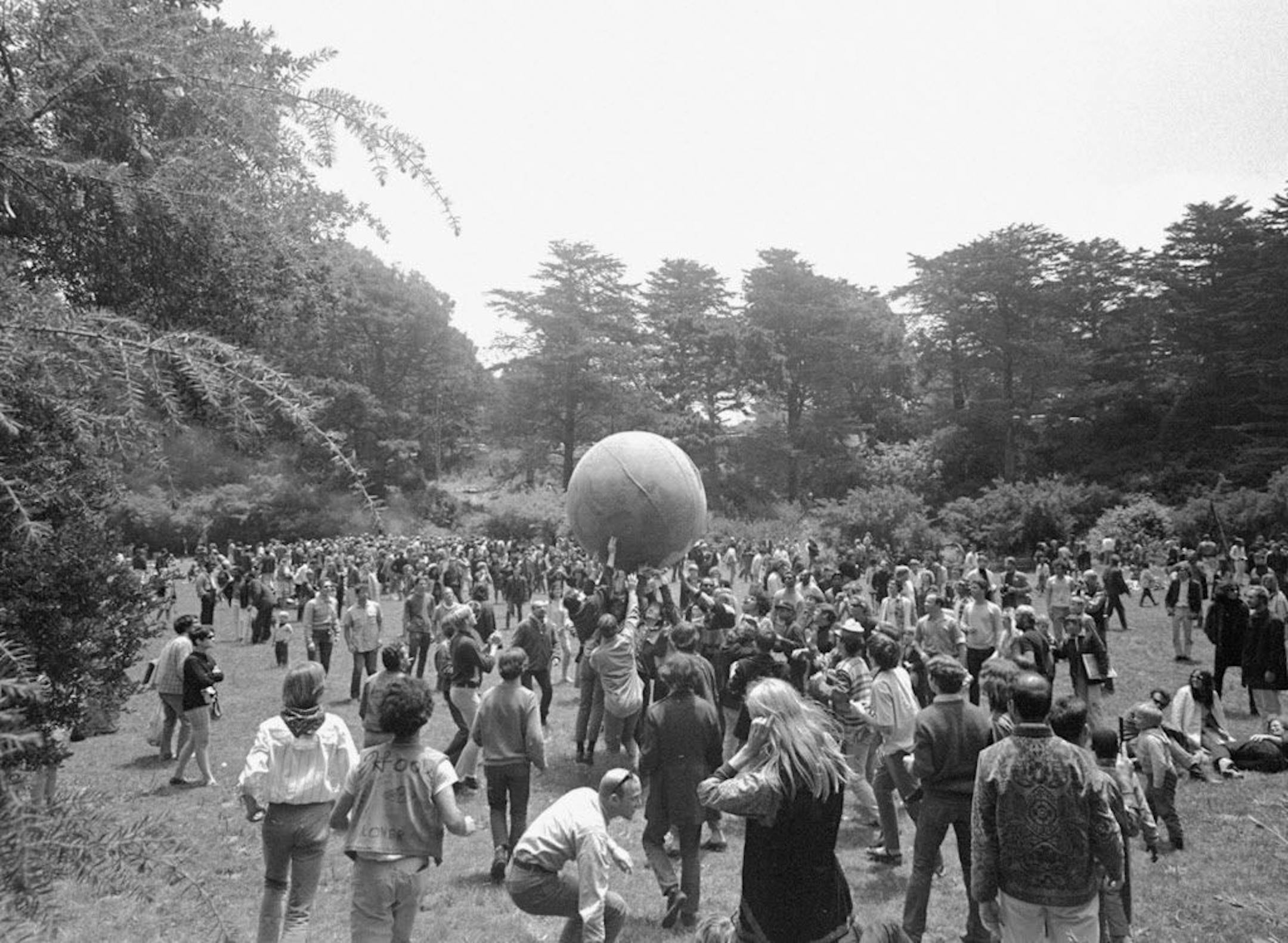 FILE - In this June 21, 1967 file photo, people keep a large ball, painted to represent a world globe, in the air during a gathering at Golden Gate Park in San Francisco, to celebrate the summer solstice on June 21, day one of "Summer of Love." City officials have rejected a permit for a planned free concert intended to mark the 50th anniversary of the famed Summer of Love in Golden Gate Park that had been planned for June 2017.