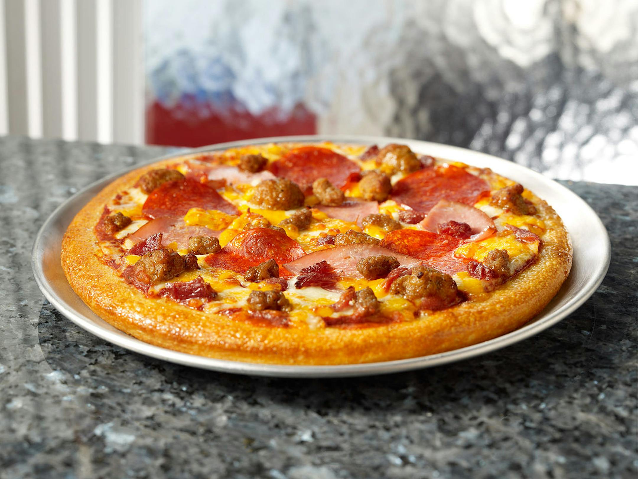 Pie Five High Five pie: A classic pan crust and Tuscan Marinara topped with pepperoni, Italian sausage, bacon, ham, beef, Mozzarella and Cheddar cheese