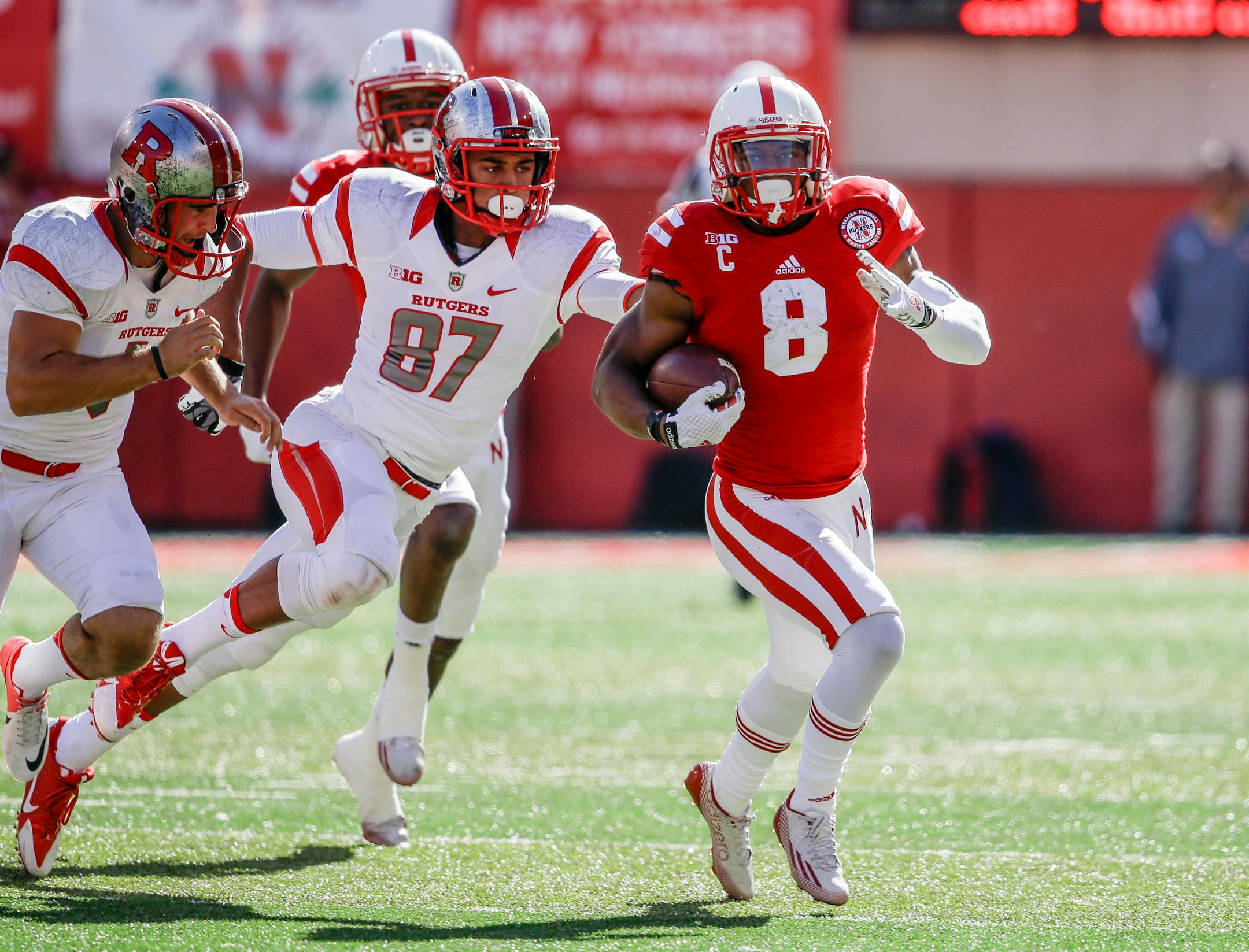 Nebraska running back Ameer Abdullah (8) runs away from Rutgers place kicker Kyle Federico (1) and Rutgers wide receiver Vance Matthews (87) on a kickoff return in the second half of an NCAA college football game in Lincoln, Neb., Saturday, Oct. 25, 2014. Nebraska won 42-24. (AP Photo/Nati Harnik) ORG XMIT: NENH1
