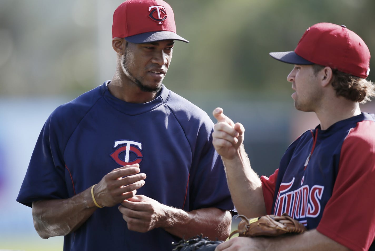 Twins infielders Pedro Florimon left and Brian Dozier chatted during practice at Lee County Sports Complex in Fort Myers.