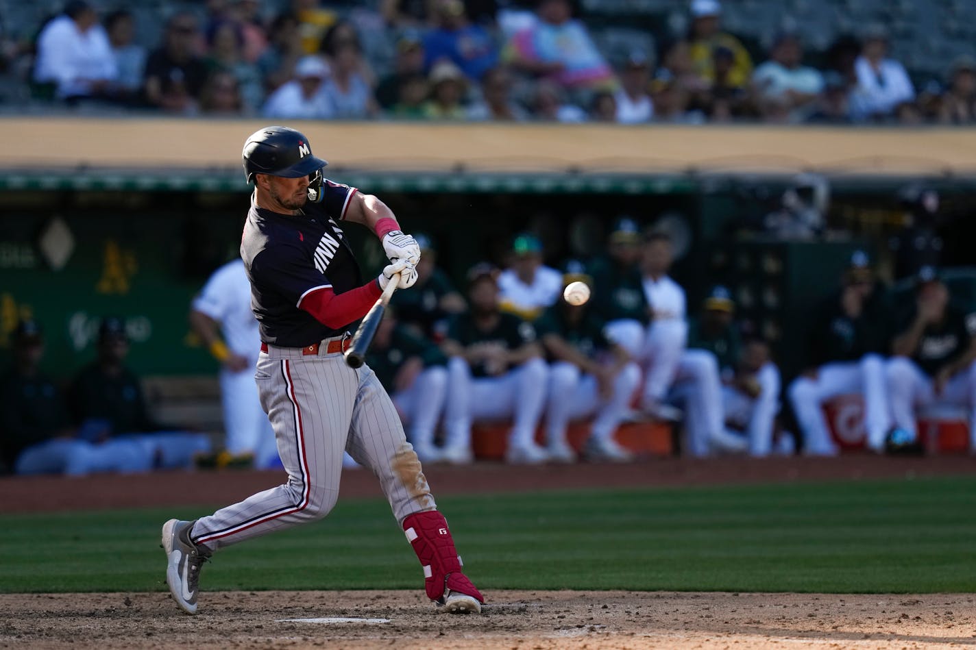 Kyle Farmer hits a solo home run against the Oakland Athletics during the seventh inning Saturday