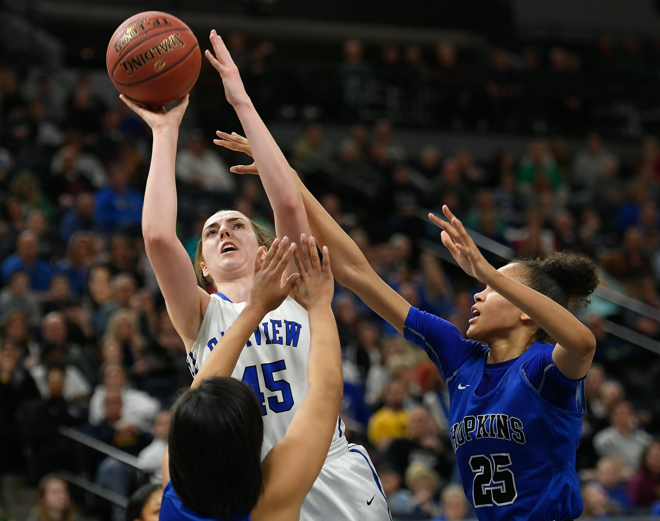 Eastview forward Megan Walstad was fouled by Hopkins forward Angelina Hammond (25) during a shot attempt in the first half of the Class 4A girls' basketball championship game.