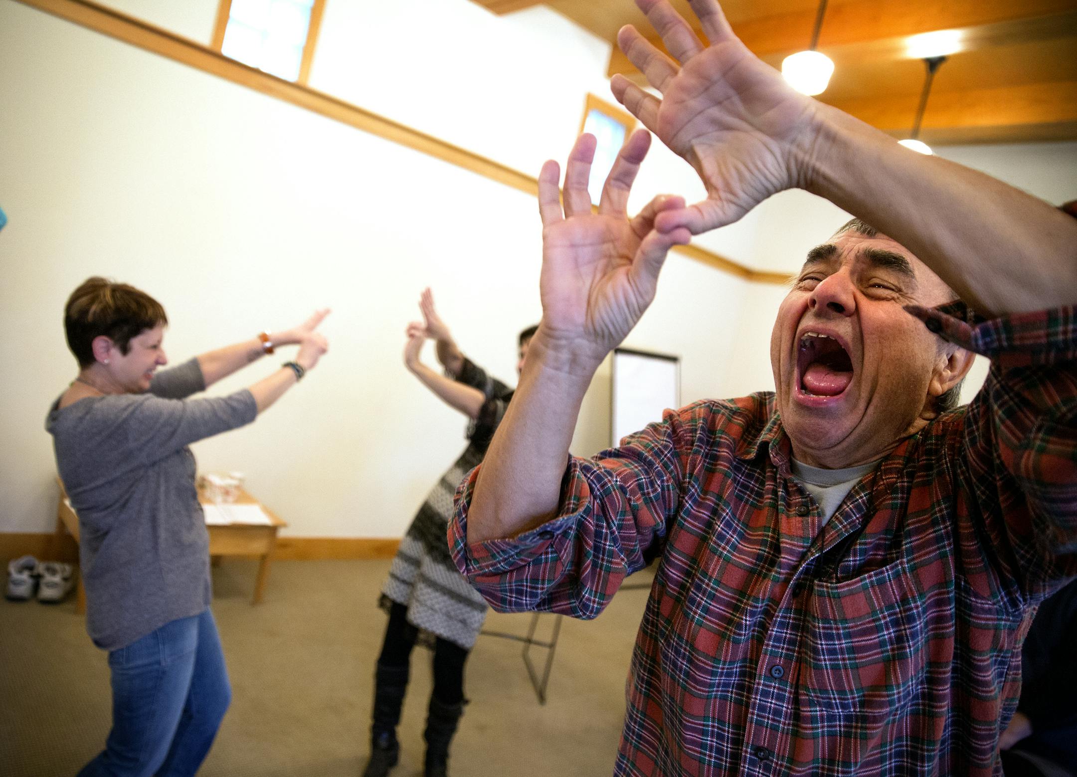 Jim Bilot did laughter yoga, in which participants get themselves laughing through goofy role play, Monday at Pathways in Minneapolis.