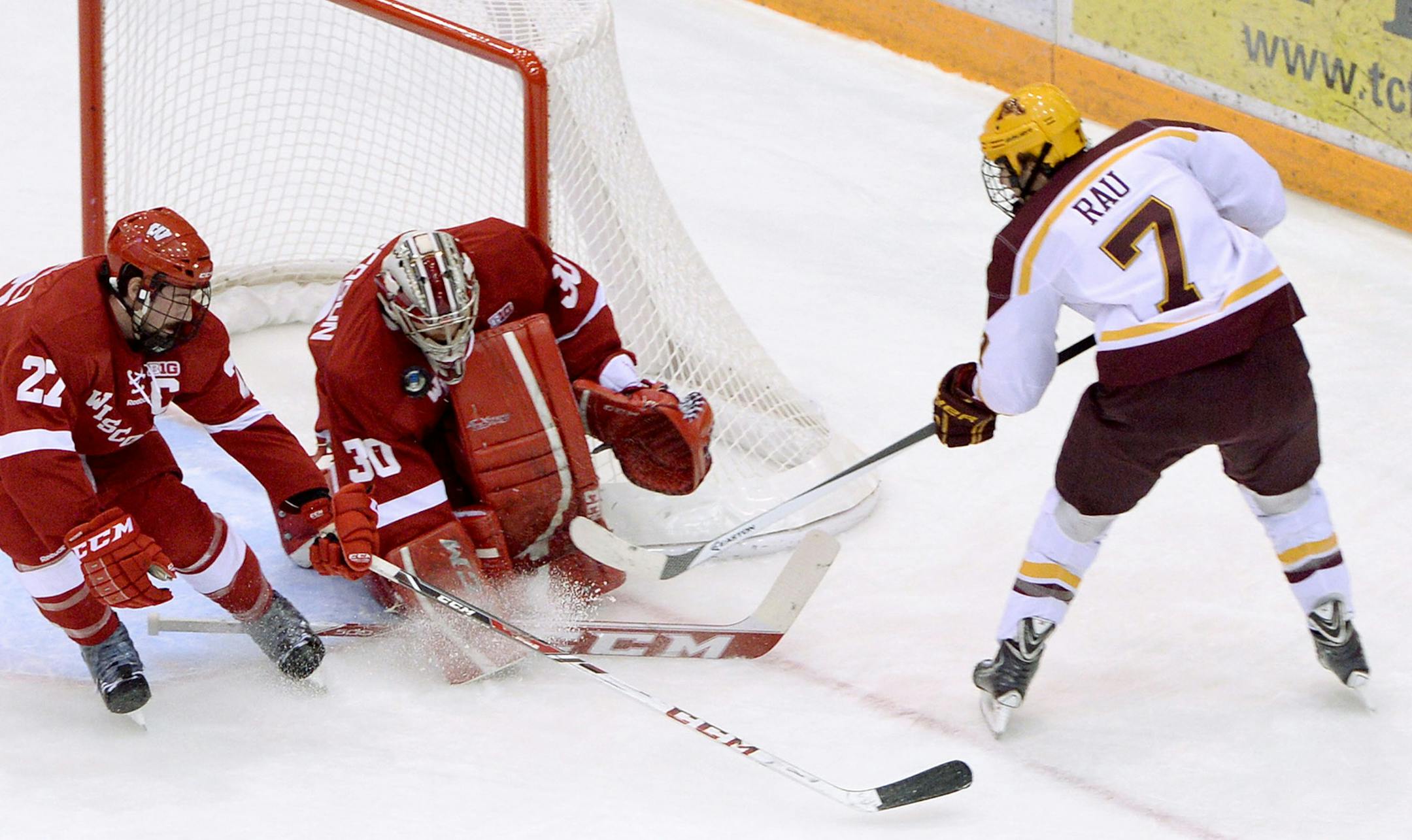 Minnesota's Kyle Rau fails to slide the puck past Wisconsin defender Frankie Simonelli and goaltender Landon Peterson during the first period of a two-game home series for the Gophers at Mariucci Arena.