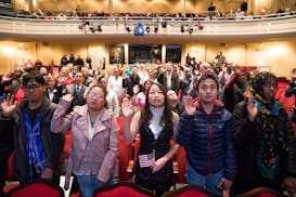 New U.S. citizens take the Oath of Allegiance to the United States at the Fitzgerald Theater in St. Paul in 2018.