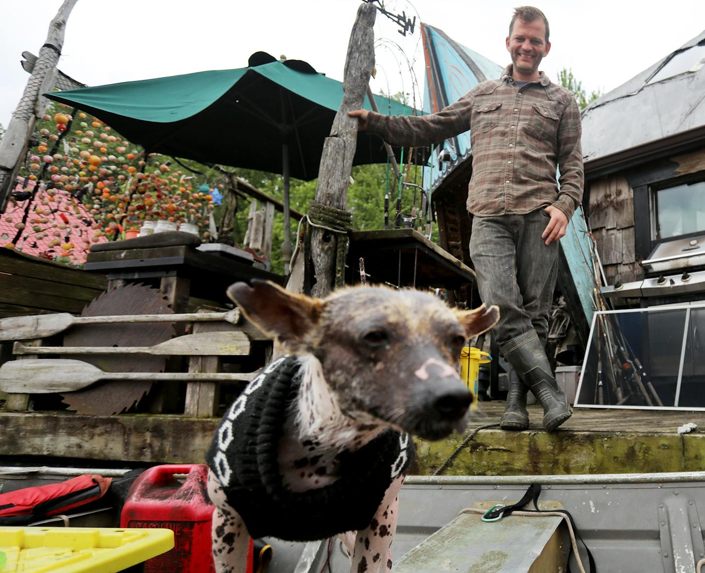 Gerty Tonjum, with his dog, has lived on the river at Winona's Latsch Island for a decade.