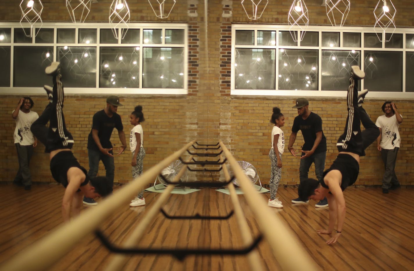 Herb Johnson worked one-on-one with his niece, Vhlincia Love, 9, during a jam session at Straightline Dance Fitness studio in Minneapolis.