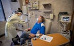 Infusion Therapy Center's Heidi Leibold, RN, administered treatment to COVID-19 patient Jay Clark at Mayo Family Clinic Northwest, Thursday, November 