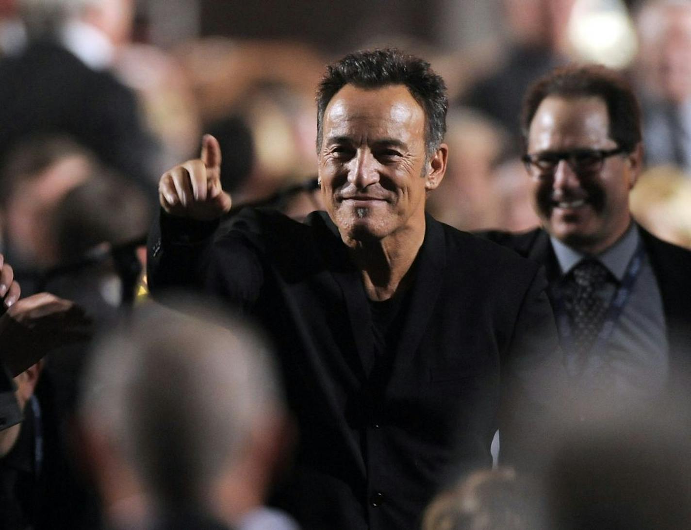 Honoree Bruce Springsteen gestures to attendees at the MusiCares Person of the Year tribute at the Los Angeles Convention Center on Friday Feb. 8, 2013, in Los Angeles.