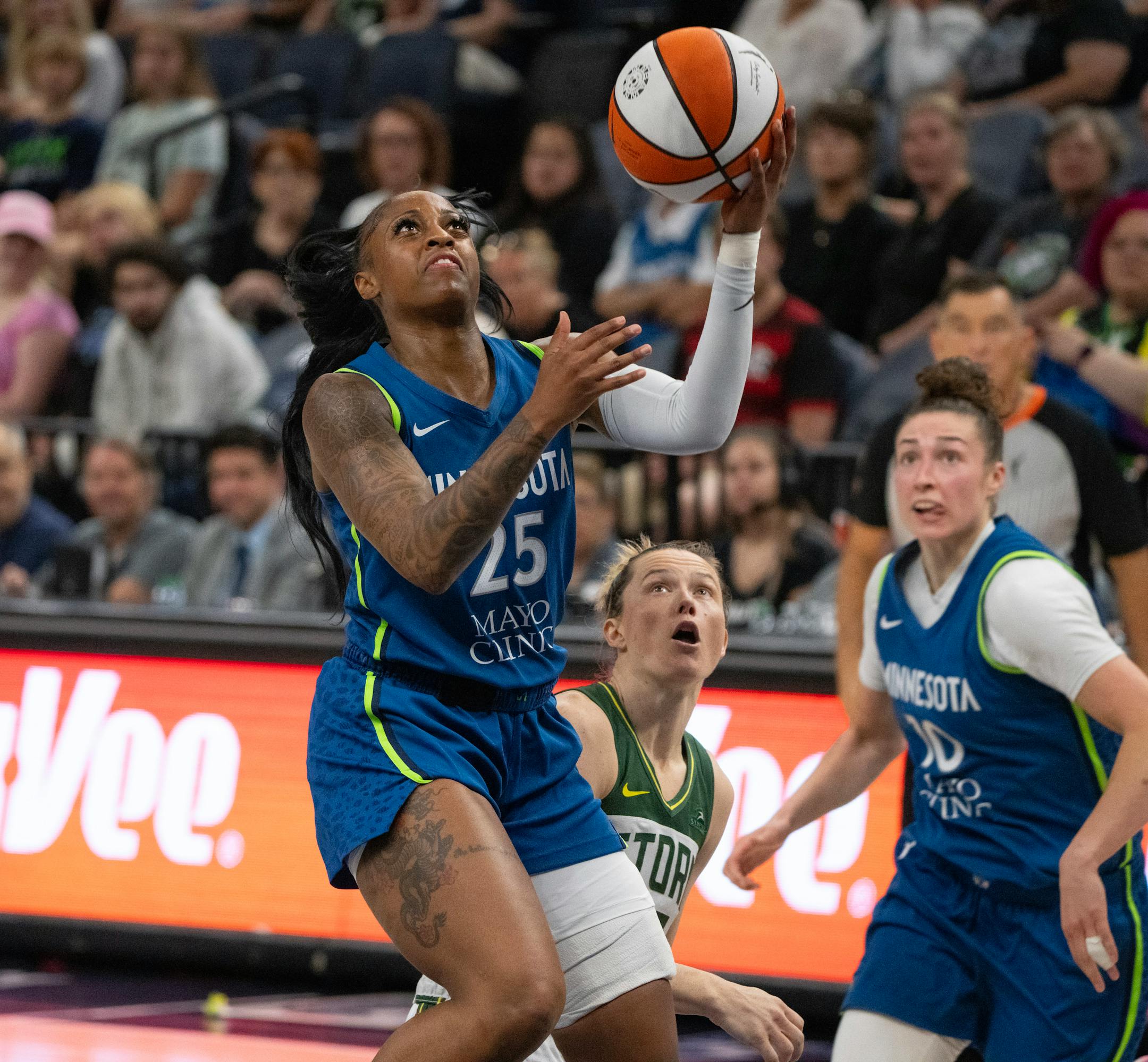 Minnesota Lynx guard Tiffany Mitchell put up a shot as the Seattle Storm's Sami Whitcomb watched in the second quarter.