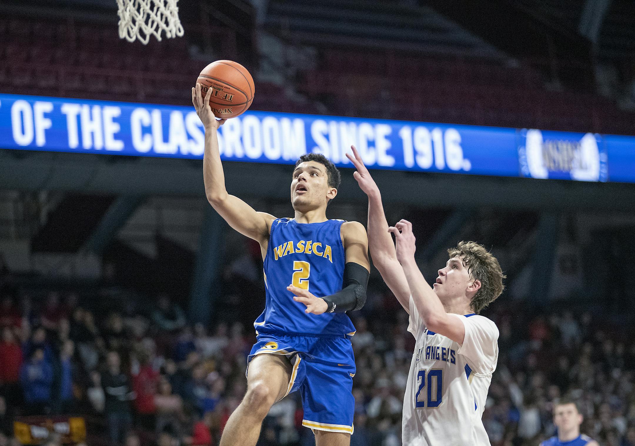 Waseca's Malik Willingham went up for two despite defensive efforts from Academy of Holy Angels' Thor Holien.