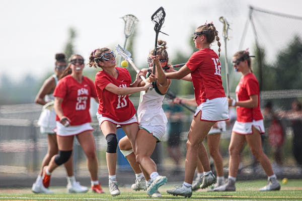 Annabelle Nicholson (13) of Benilde-St. Margaret's crashed into Edina's Nicola Santini in the second half of the girls lacrosse state final on Saturda
