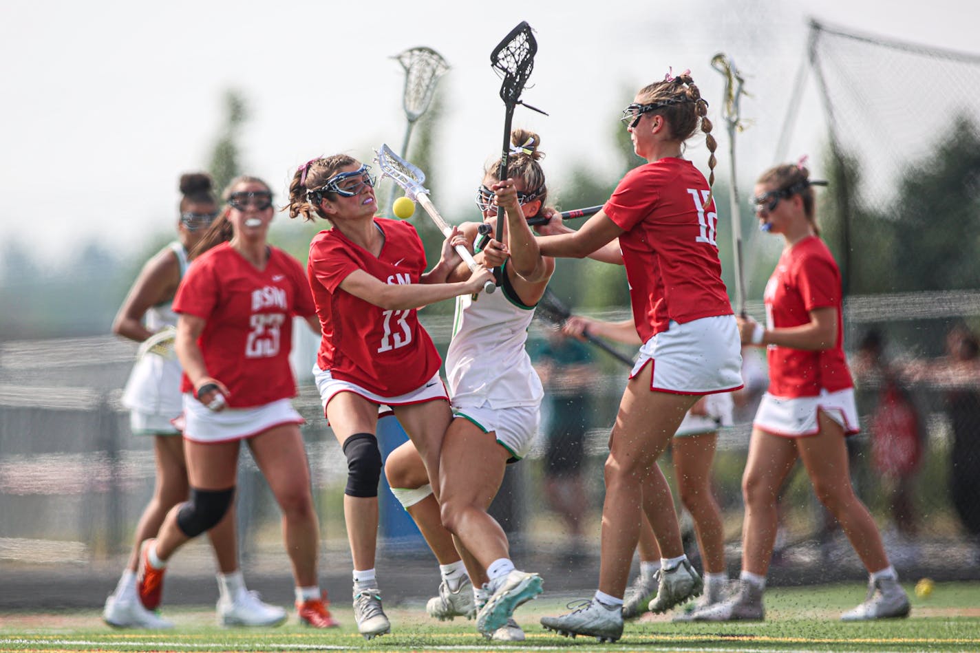 Annabelle Nicholson (13) of Benilde-St. Margaret's crashed into Edina's Nicola Santini in the second half of the girls lacrosse state final on Saturday.