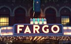 The neon of the Fargo Theatre glows along Broadway.