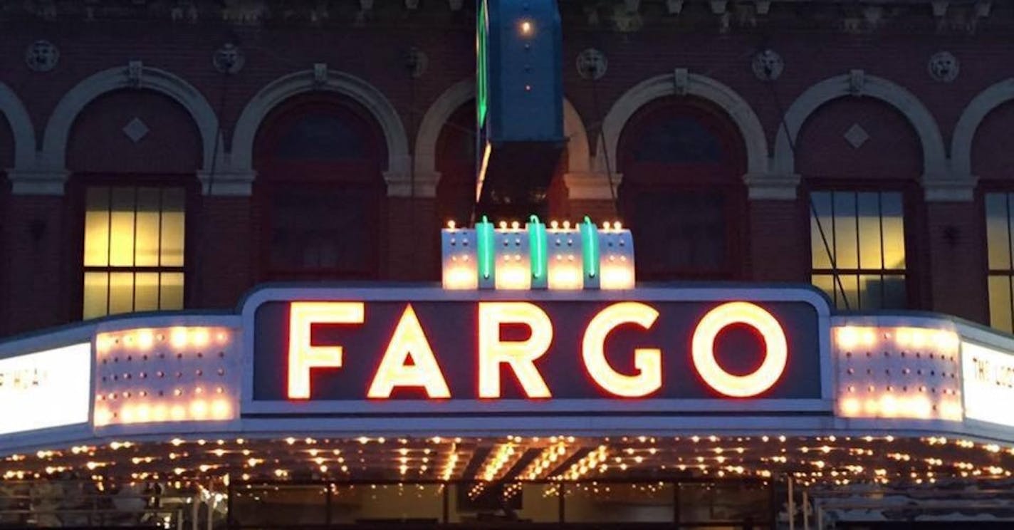 The neon of the Fargo Theatre glows along Broadway.