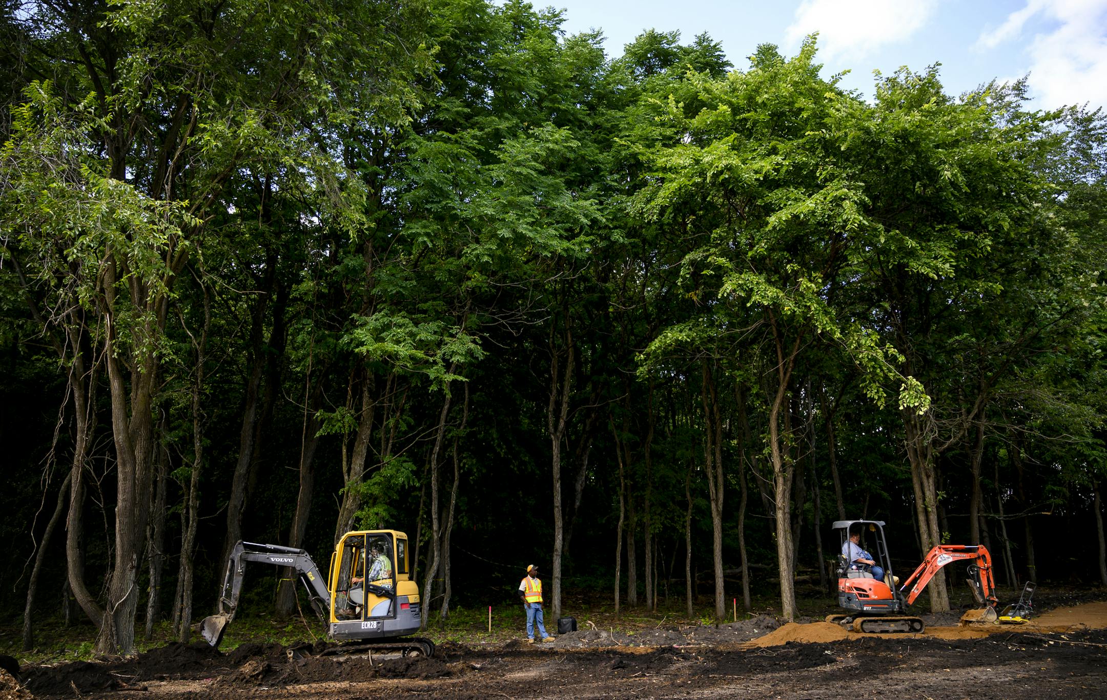 Adnane Afoda, left of center, an inspector with Carver County, oversaw contractors building a trail on Coney Island of the West Tuesday. ] Aaron Lavinsky &#x2022; aaron.lavinsky@startribune.com Carver County has begun work on enlarging the long-awaited Lake Waconia Regional Park, a project in the works since 1996. They're finding chips of ancient pottery (as many as 1,500-2000 years old) as they dig walking trails on the island in the middle of Lake Waconia, Coney Island of the West. They're wor