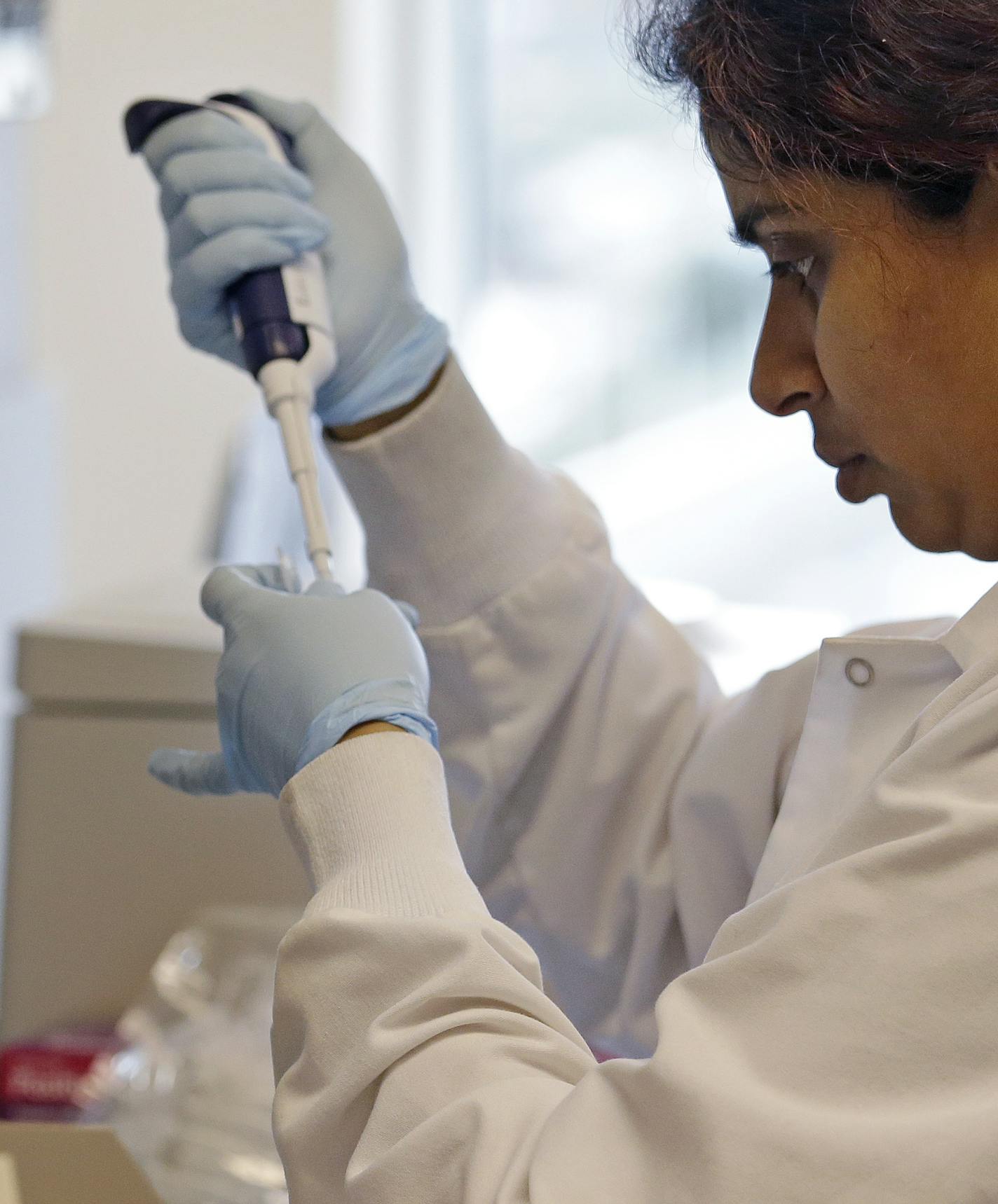 In this photo taken March 28, 2017, research technician Ashwini Balakrishnan works in the immunotherapy research lab of Dr. Stanley Riddell at the Fred Hutchinson Cancer Research Center in Seattle. (AP Photo/Elaine Thompson) ORG XMIT: WX207