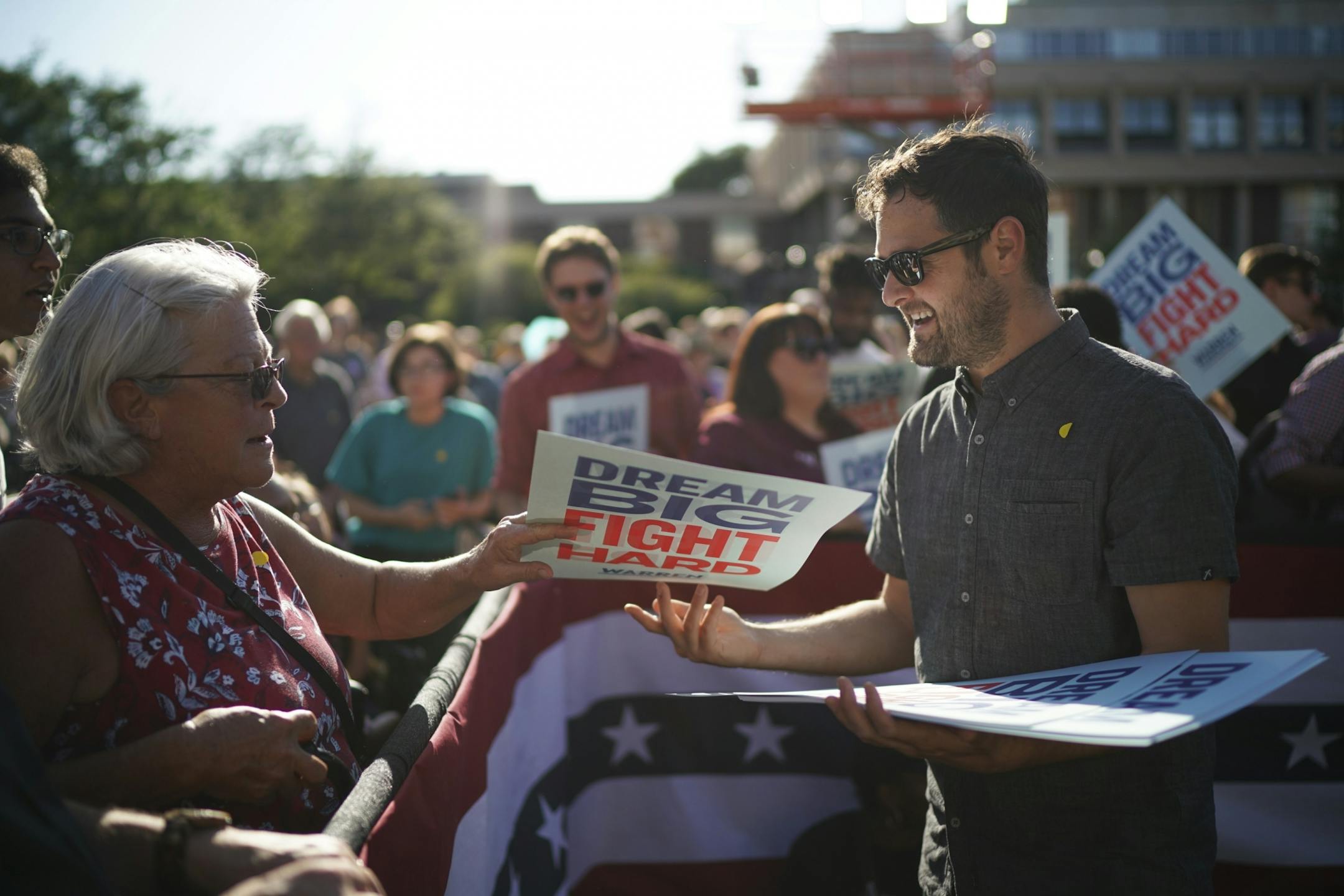 Warren campaign volunteer Tim Schumann handed out signs before the Town Hall began.