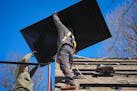 Workers from TruNorth Solar install a rooftop solar panel power system on Thursday, April 4, 2024 in Golden Valley, Minn.    ] GLEN STUBBE • glen.st