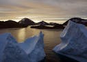 FILE - This early Friday, Aug. 16, 2019 file photo shows an aerial view of large Icebergs floating as the sun rises near Kulusuk, Greenland. Greenland