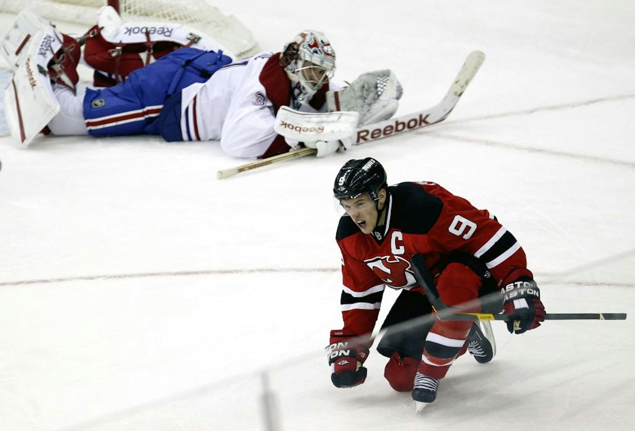 New Jersey Devils' Zach Parise (9) celebrates his goal as Montreal Canadiens goalkeeper Carey Price lays on the ice during the third period of an NHL hockey game, Thursday, Feb. 2, 2012, in Newark, N.J. The New Jersey Devils won 5-3.