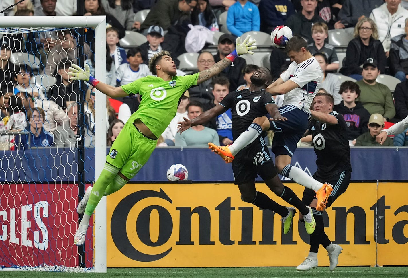 Vancouver's Ranko Veselinovic, second right, heads the ball wide of the goal behind Minnesota United goalkeeper Dayne St. Clair during the first half Saturday.