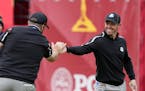 Team Europe’s Tyrrell Hatton congratulates Rory McIlroy after a putt on the ninth hole during a practice day at the Ryder Cup on Thursday. 