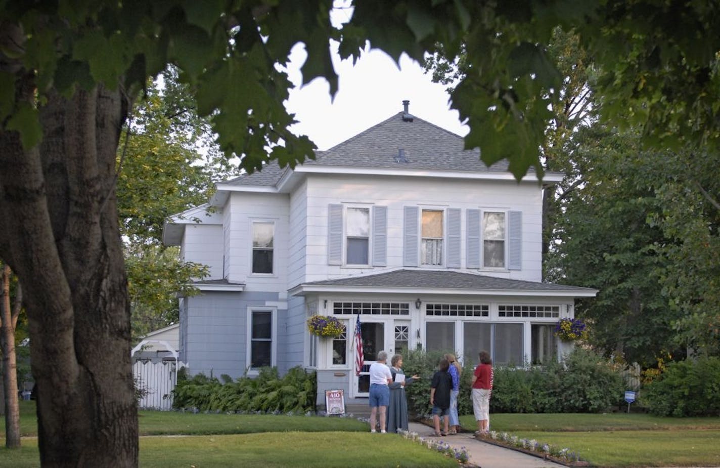 The tour, led by Ann Steen, (in long dress) stopped at this 1883 home on Van Buren St.,. Homeowners say that a playful spirit occupies their home. Strange experiences they can't explain include this mechanical doorbell ringing without apparent reason, even while they are watching the door and can see no one nearby. Their fire detector has gone off at 5:00 for several mornings in a row, even after they've removed the batteries. GENERAL INFORMATION: DARLENE PROIS � dprois@startribune.com ocal home