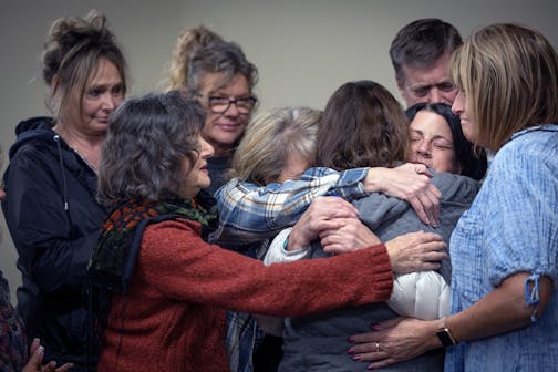 Thrive! Family Recovery Resources support group surround Deirdre Johnson only days after her daughter died of a fentanyl overdose, in Lakeville, Minn.