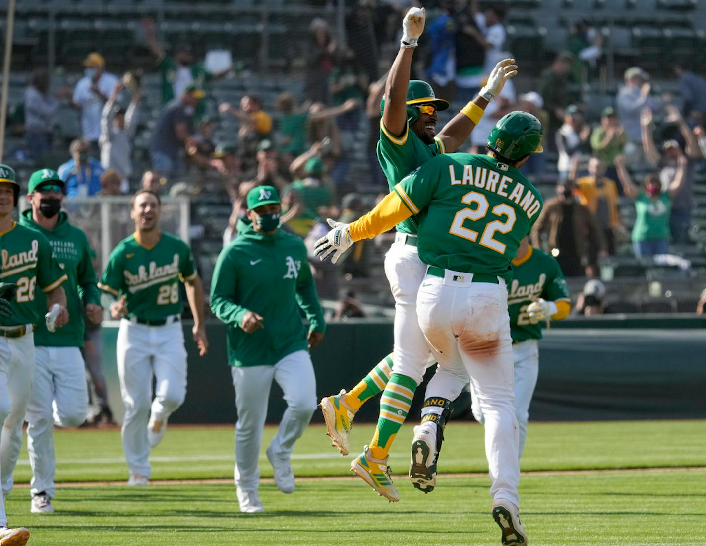 Oakland Athletics' Ramon Laureano (22) celebrates with Tony Kemp (5) Wednesday.