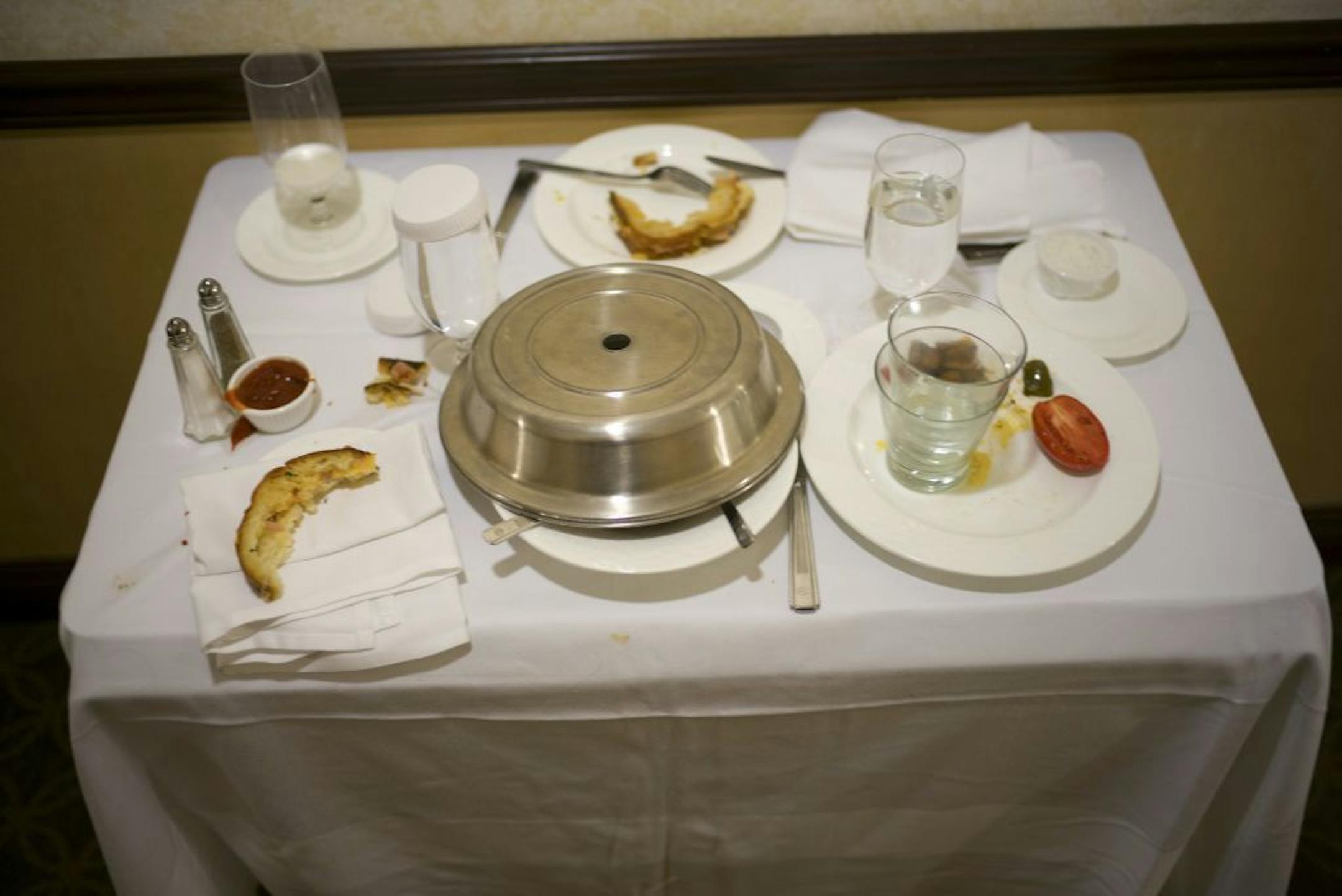 A cart with finished room-service orders at the New York Hilton Midtown. In August, the hotel will discontinue food and drink service to all 2,000 of its rooms; in its place will be a new cafeteria-style restaurant that will be stocked with grab-and-go items.