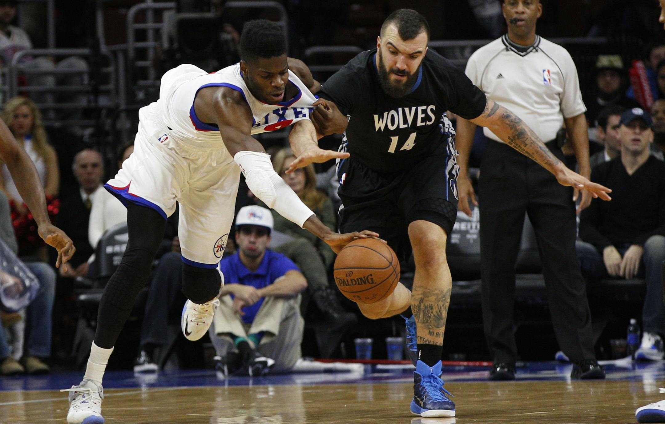 Philadelphia 76ers' Nerlens Noel (4) and Minnesota Timberwolves' Nikola Pekovic (14) of Montenegro battle for the loose ball during the second half of an NBA basketball game, Friday, Jan. 30, 2015, in Philadelphia. The 76ers won 103-94. (AP Photo/Chris Szagola)