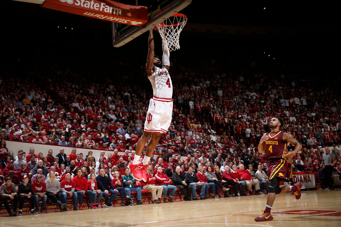 Indiana guard Robert Johnson scores on a breakaway dunk in front of Minnesota guard Jamir Harris during the second half of an NCAA college basketball game in Bloomington, Ind., Friday, Feb. 9, 2018. Indiana won 80-56. (AP Photo/AJ Mast)