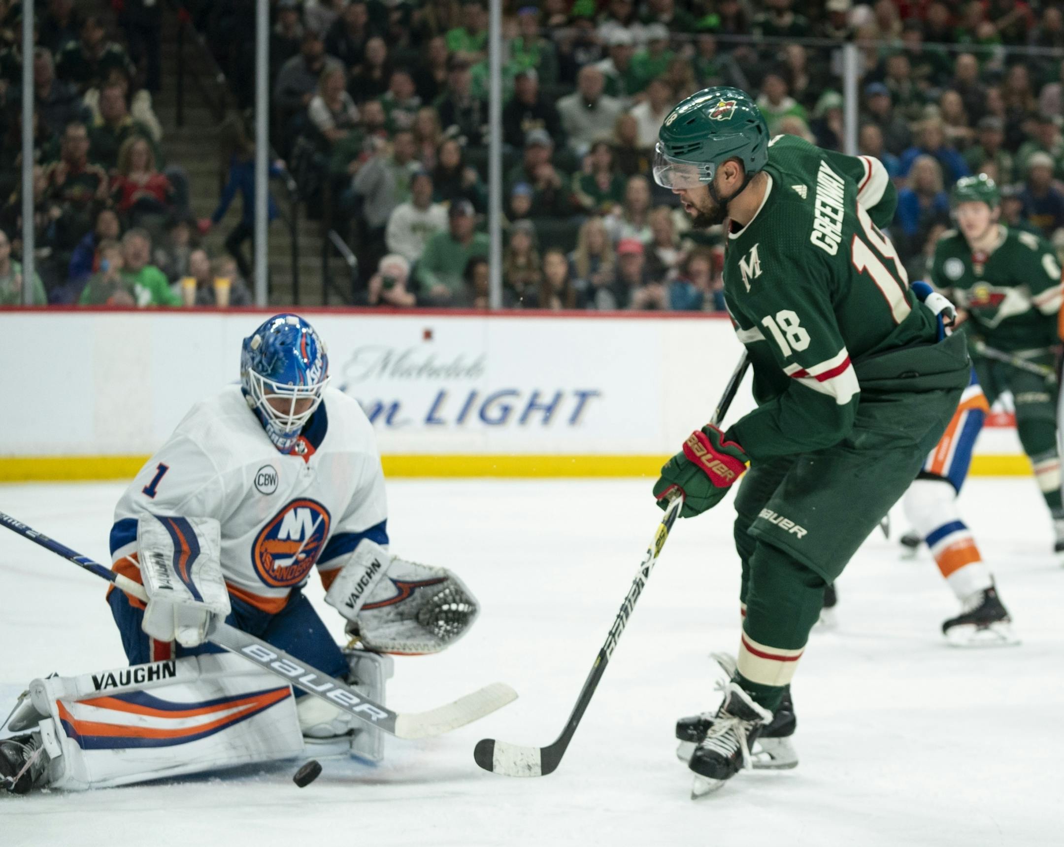 Minnesota Wild left wing Jordan Greenway (18) shot the puck on New York Islanders goaltender Thomas Greiss in the second period.