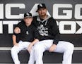 Chicago White Sox designated hitter Adam LaRoche (25) sits with his son Drake, 13, in the White Sox dugout at U.S. Cellular Field before a game agains
