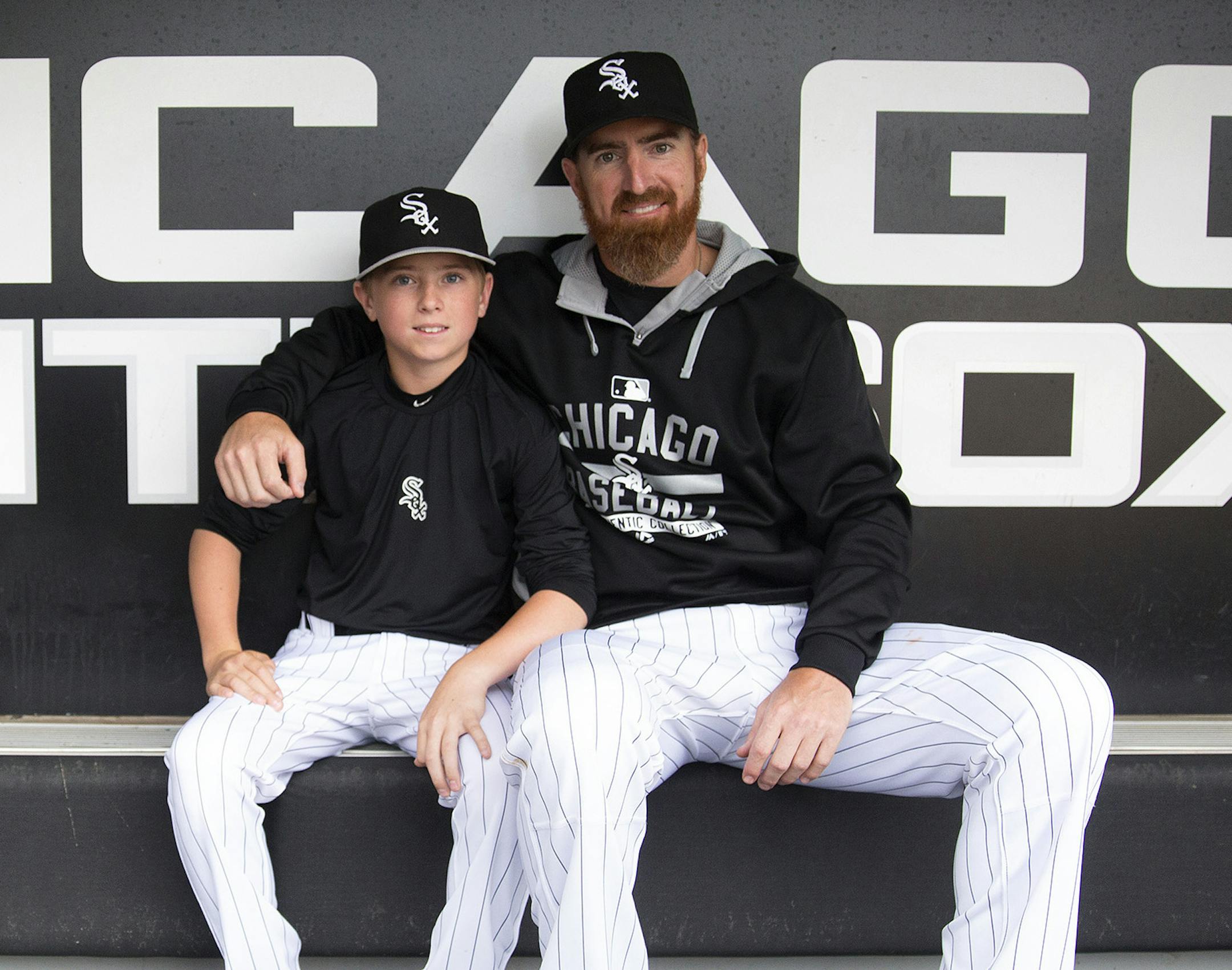 Chicago White Sox designated hitter Adam LaRoche (25) sits with his son Drake, 13, in the White Sox dugout at U.S. Cellular Field before a game against the Houston Astros on June 8, 2015 in Chicago. (Erin Hooley/Chicago Tribune/TNS) ORG XMIT: 1182088