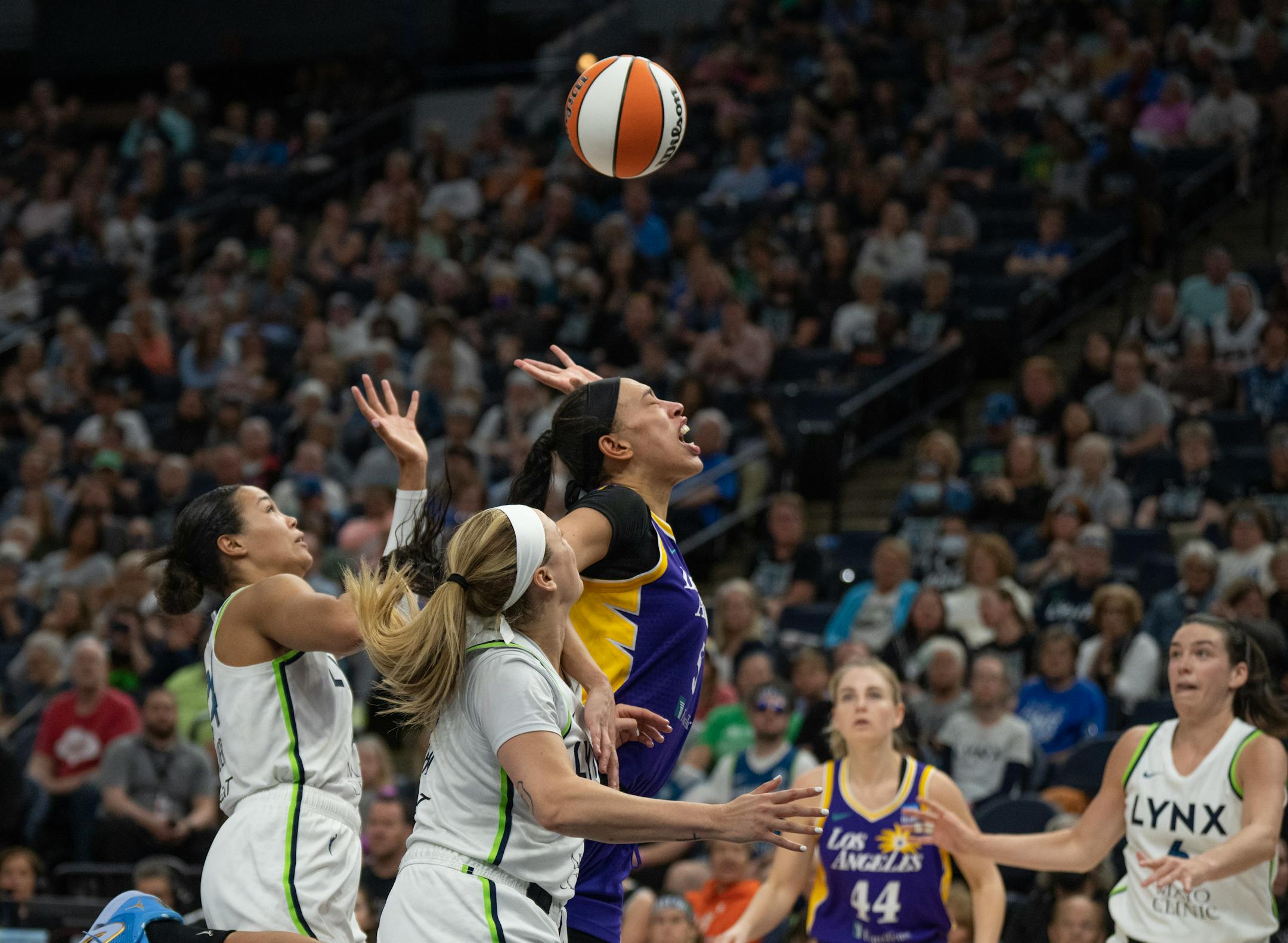 Los Angeles Sparks forward Dearica Hamby (5) battled Minnesota Lynx forward Napheesa Collier, left and guard Rachel Banham for a loose ball in the second half.