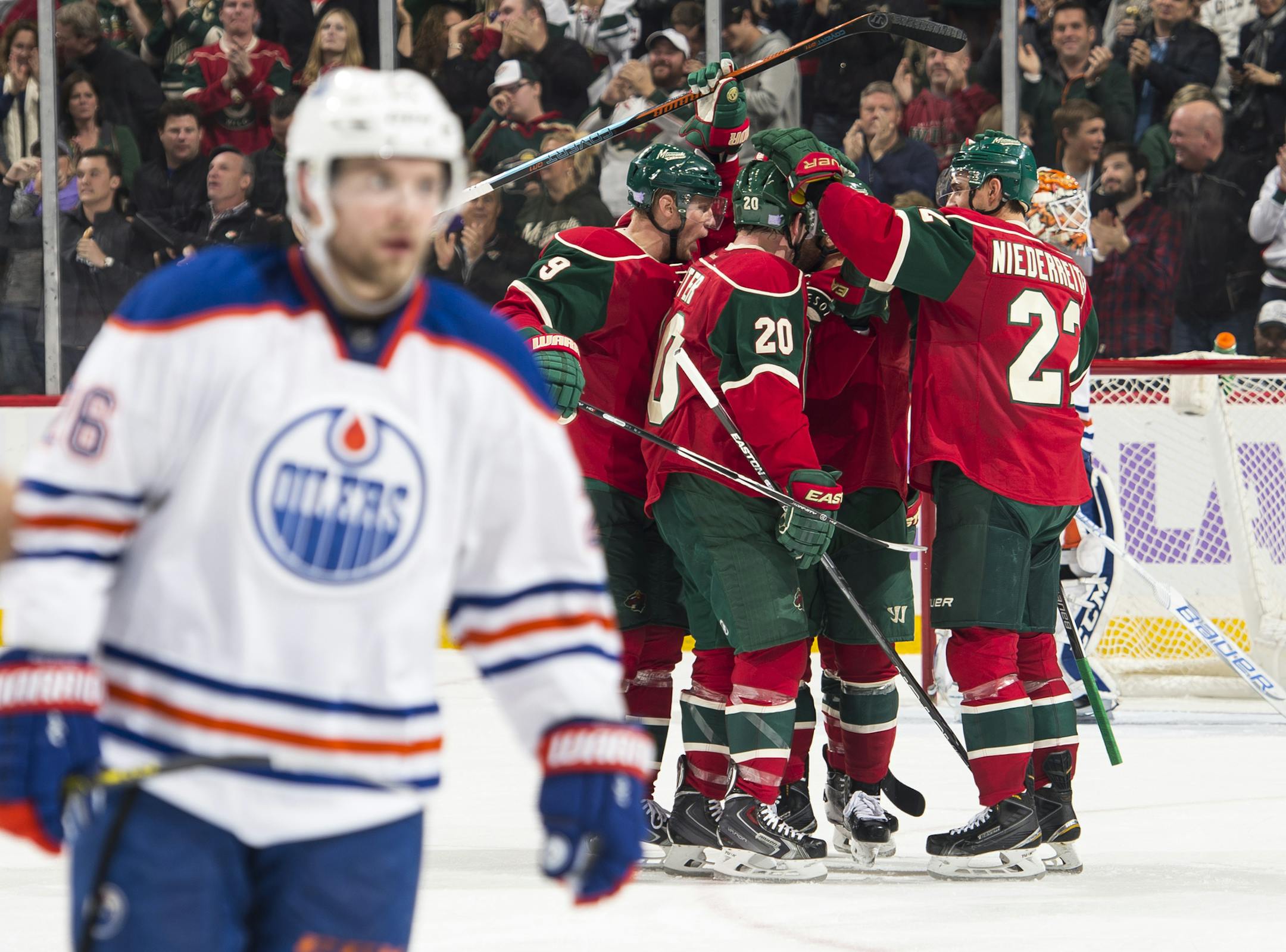 Edmonton Oilers right wing Iiro Pakarinen (26) skated back to the bench as Wild players celebrated around defenseman Ryan Suter (20) after his goal in the third period Tuesday. ] (AARON LAVINSKY/STAR TRIBUNE) aaron.lavinsky@startribune.com The Minnesota Wild played the Edmonton Oilers on Tuesday, Oct. 27, 2015 at Xcel Energy Center in St. Paul, Minn.