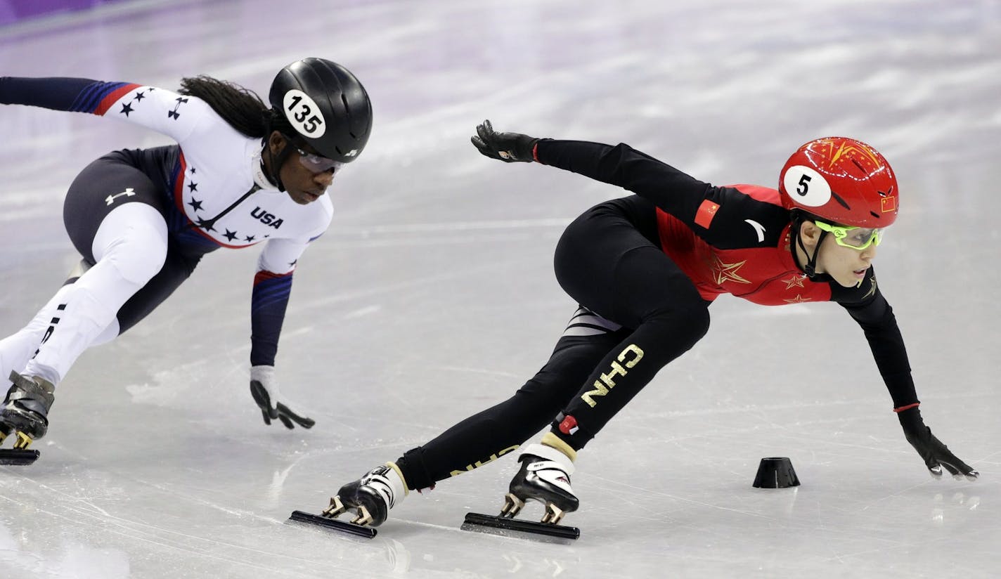 Kexin Fan of China leads Maame Biney of the United States in their ladies' 500 meters short-track speedskating heat in the Gangneung Ice Arena at the 2018 Winter Olympics in Gangneung, South Korea, Saturday, Feb. 10, 2018. (AP Photo/David J. Phillip)