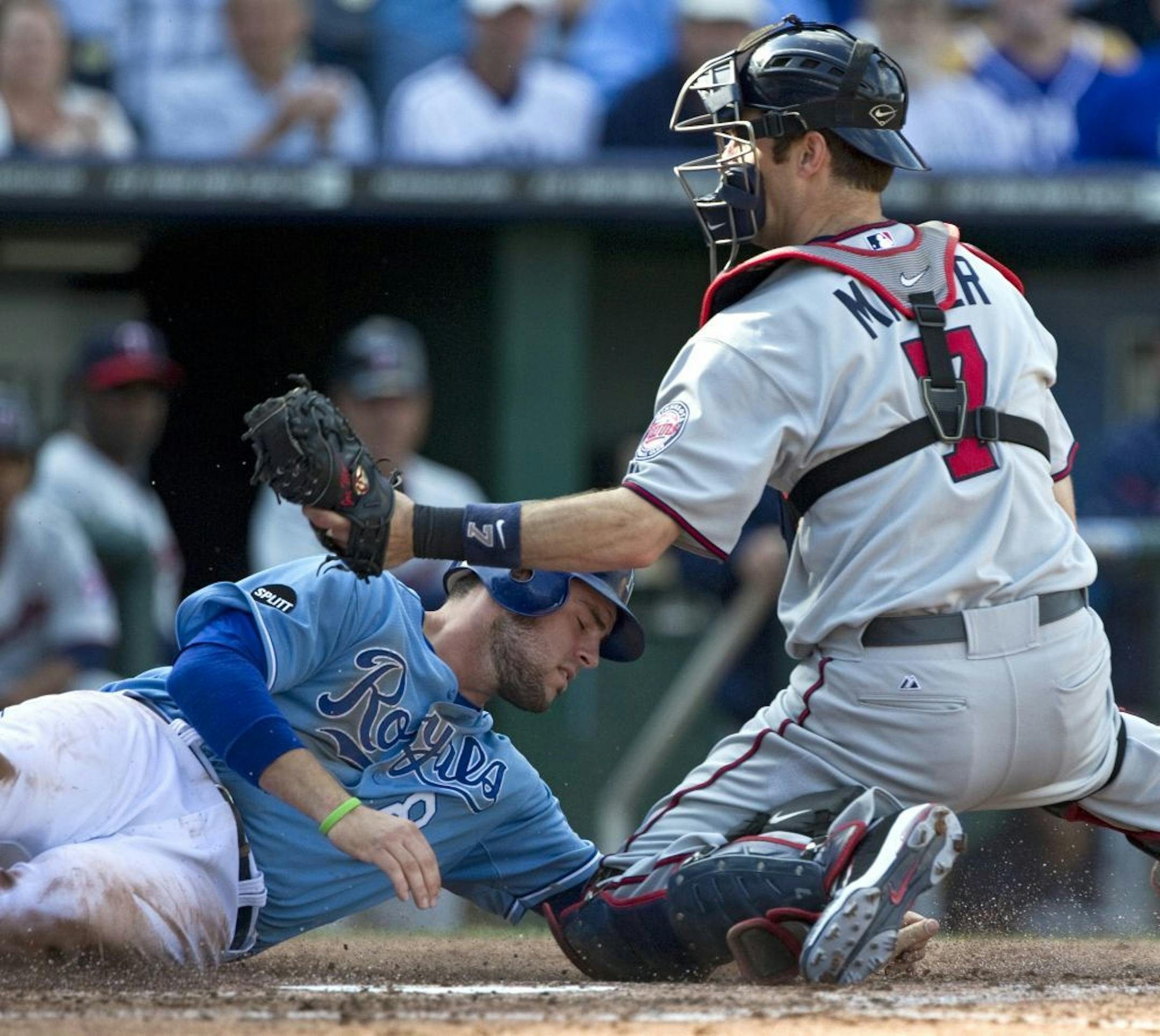 Kansas City Royals' Mike Moustakas was tagged out at the plate by Twins catcher Joe Mauer in the fourth inning Wednesday. The Royals won 7-3.