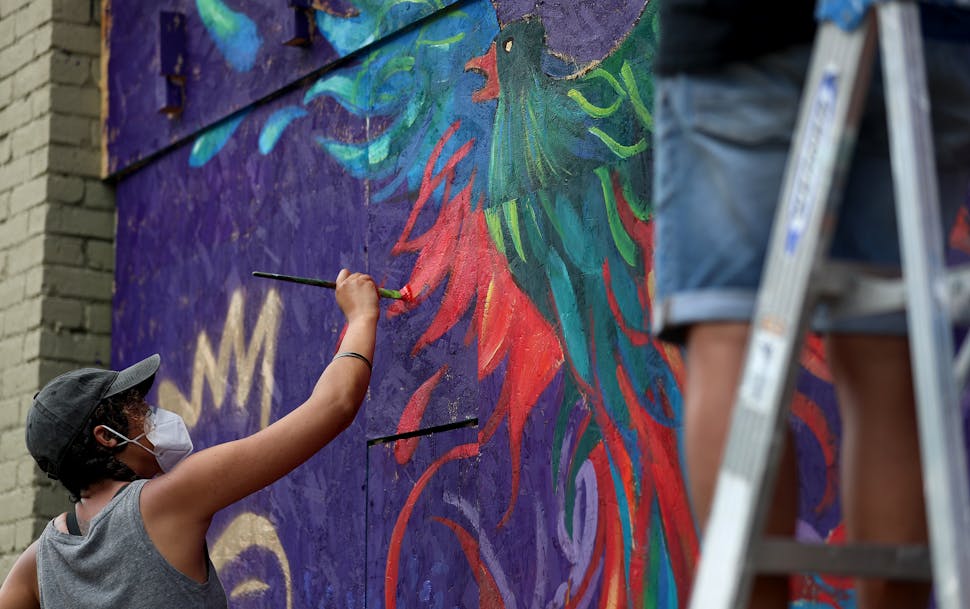 Renowned local artist Leslie Barlow and a crew painted a mural on the boarded up front of Fall Out Arts Initiative in the wake of the death of George 