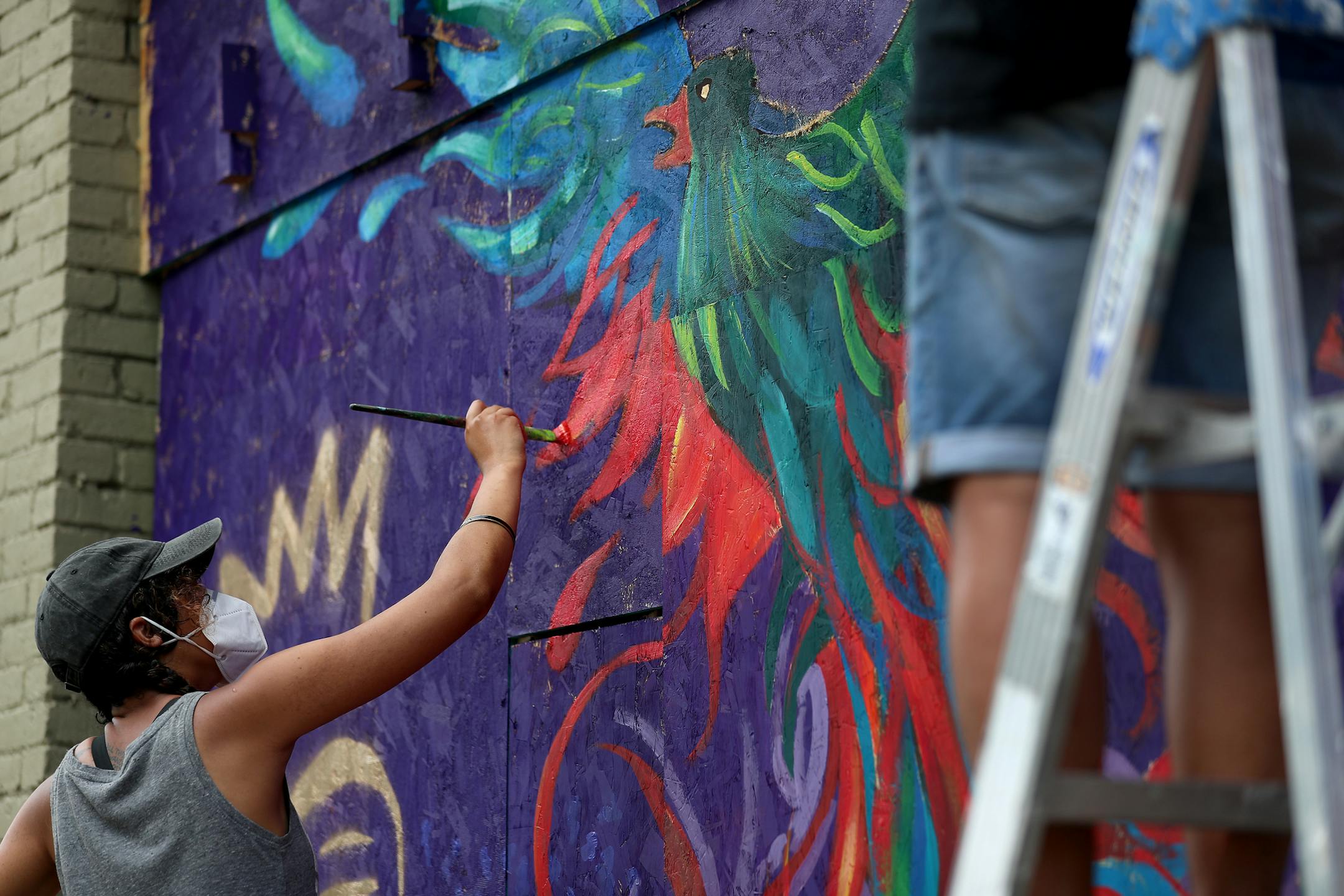 Renowned local artist Leslie Barlow and a crew painted a mural on the boarded up front of Fall Out Arts Initiative in the wake of the death of George Floyd.