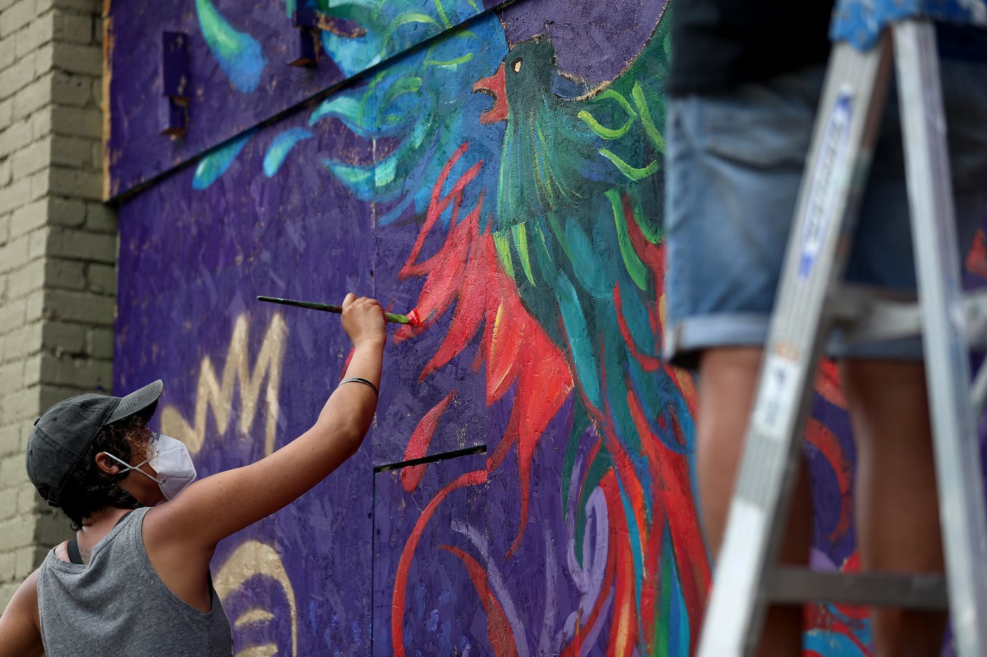 Renowned local artist Leslie Barlow and a crew painted a mural on the boarded up front of Fall Out Arts Initiative in the wake of the death of George Floyd.