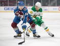 Jacob MacDonald (34) of the Colorado Avalanche and Luke Johnson (41) of the Minnesota Wild fought for the puck in the first period.
