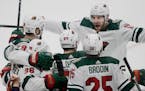 The Wild's Marcus Foligno, above right, celebrates with Greg Pateryn, left, Mats Zuccarello, second from left and Jonas Brodin after a goal on March 8